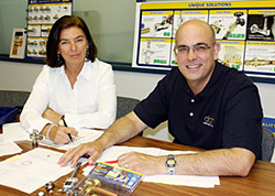 A photo of Jannike Godfrey (daughter), Dahl Valve Limited President with Thomas D. Husebye (son), VP Marketing collaborating at a boardroom table.
