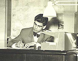 A B&W photo of Dahl Valve Limited visionary Trygve Husebye sitting at a desk signing papers.